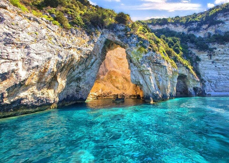 A coastal cave entrance with clear turquoise water. 1