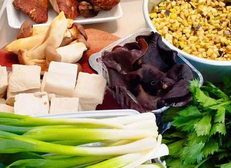 Various food items including tofu, mushrooms, corn, and leafy greens. 5
