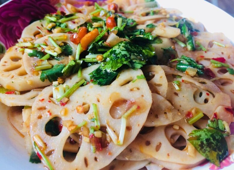 A dish with sliced vegetables and herbs. 2