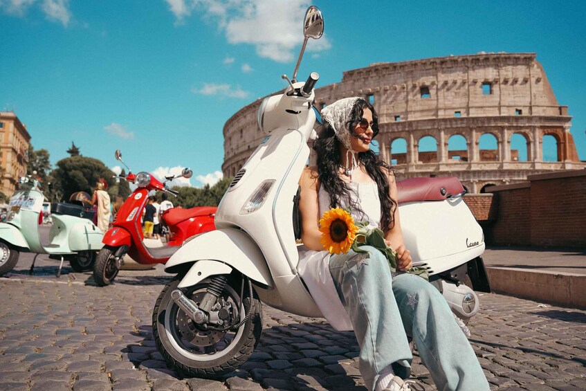 A person sitting on a white scooter with a sunflower, in front of the Colosseum. 1