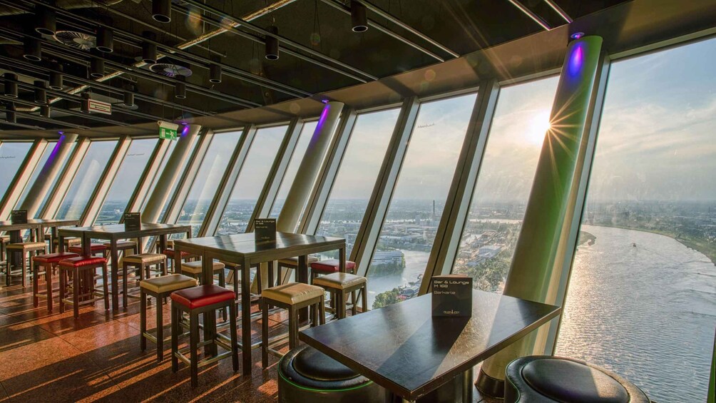 A restaurant with a view of a river and cityscape. 1