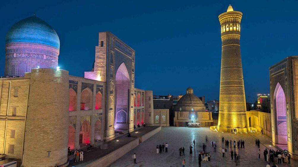A historic square with illuminated buildings and a prominent minaret. 1