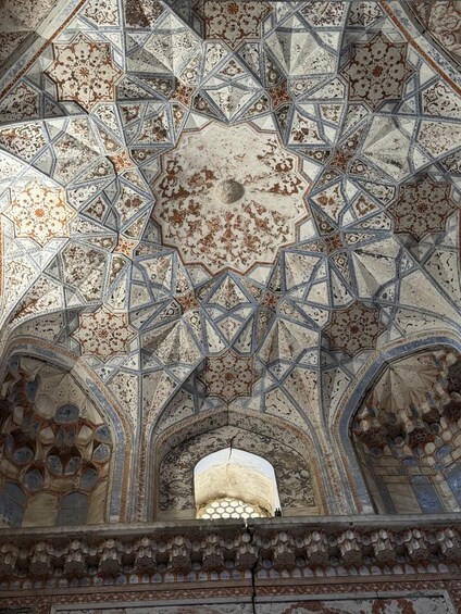 A detailed ceiling with geometric patterns and a central dome. 4