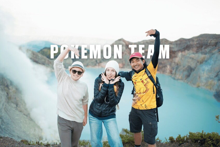 Three people posing with a mountainous landscape and a lake in the background. 5