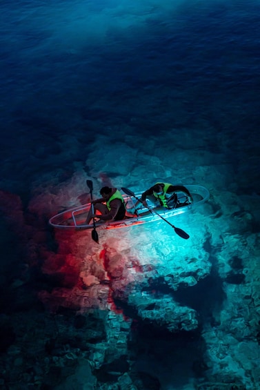 A kayak submerged underwater with a person wearing a life jacket. 4