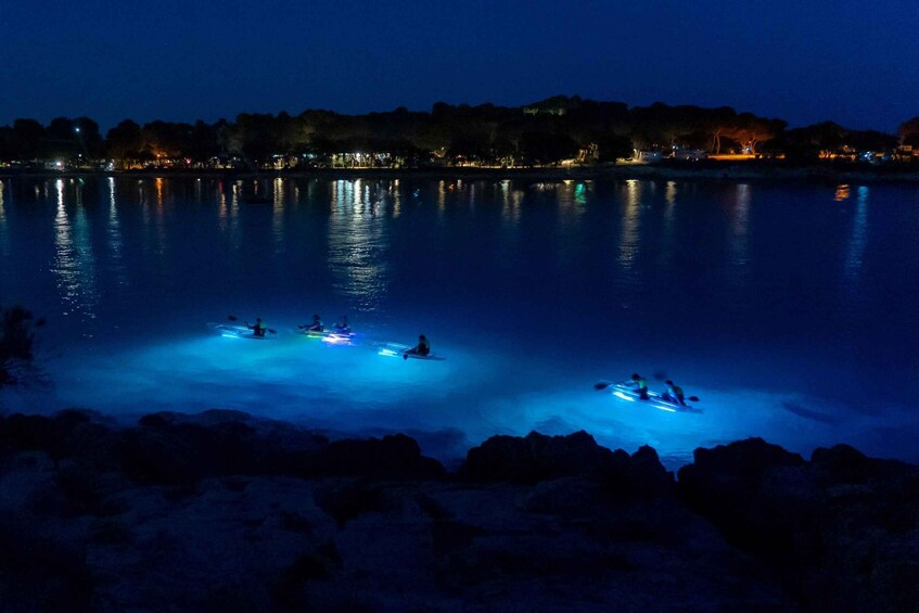 A nighttime scene with a calm body of water reflecting city lights. 5