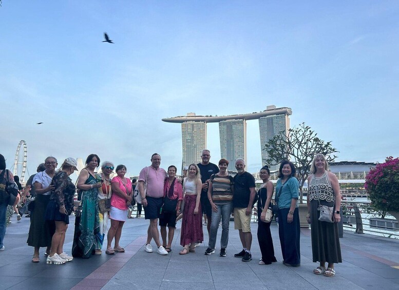 A group of people standing in front of the Marina Bay Sands hotel in Singapore. 2