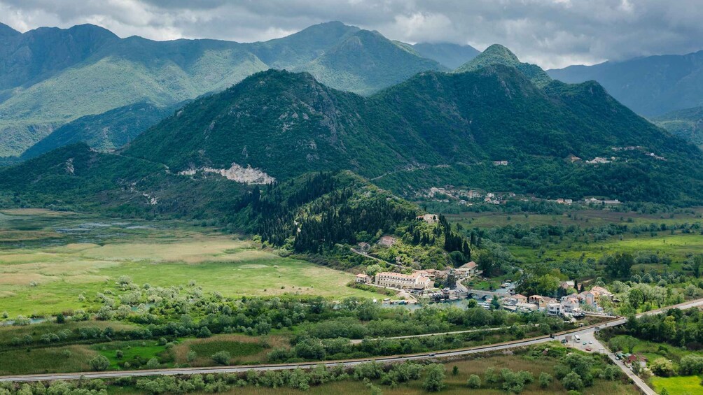 A mountainous landscape with a village nestled among the hills. 1