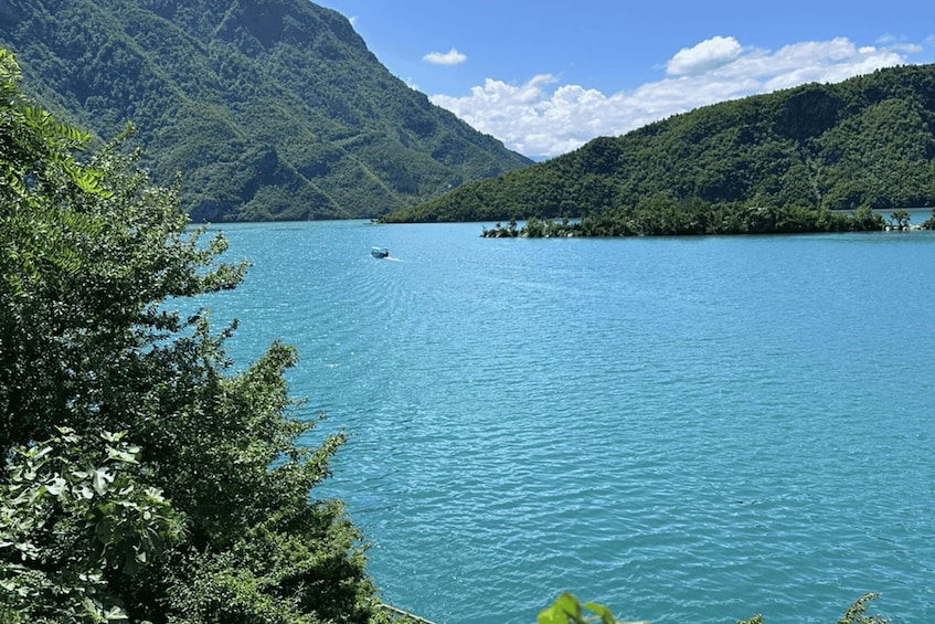 A calm lake surrounded by lush green hills. 5