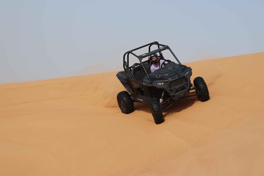 A black off-road vehicle on a sandy dune. 3