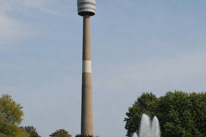A tall chimney with a water fountain at its base. 3