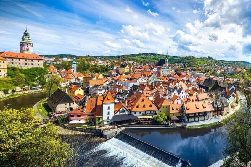 A historic town with a river, a castle, and a church. 3
