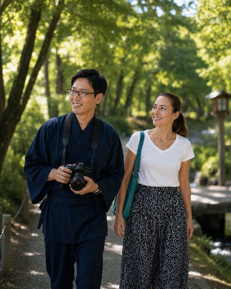 Two people walking on a path in a park with trees and a stone lantern in the background. 4
