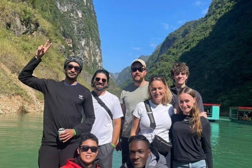 A group of people on a boat in a river canyon with steep cliffs. 5