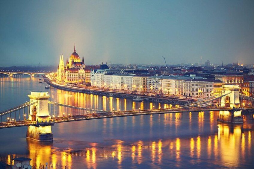 A cityscape with a prominent domed building reflecting on the water, a bridge spanning the river, and a distant skyline. 5