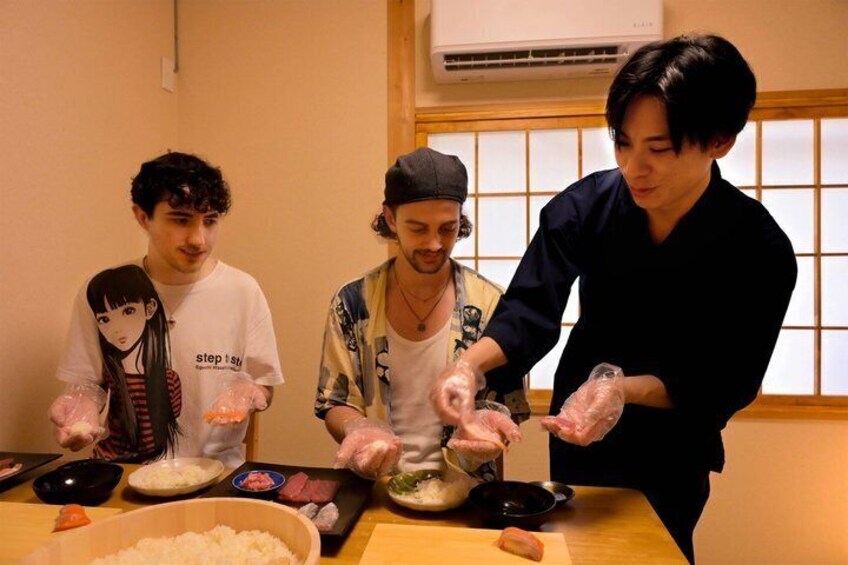 Three people preparing food with bowls and chopsticks. 1