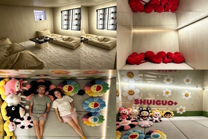 A room with a sofa, a small table, and a wall with colorful flower decorations. 2