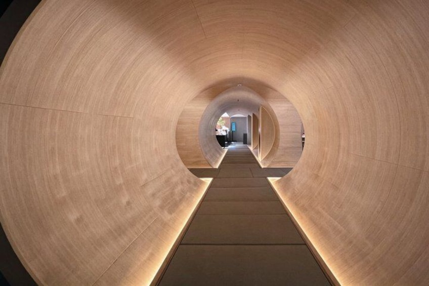 A cylindrical wooden structure with a central walkway. 4