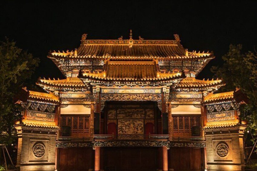 A traditional Chinese gate with ornate decorations and a tiled roof. 5