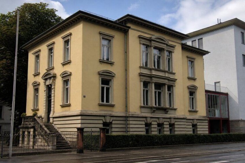 A yellow building with multiple windows and a staircase. 5