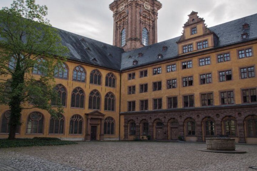 A historic building with arched windows and a central tower. 3