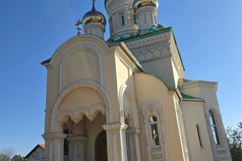 A church with multiple domes and arched windows. 2