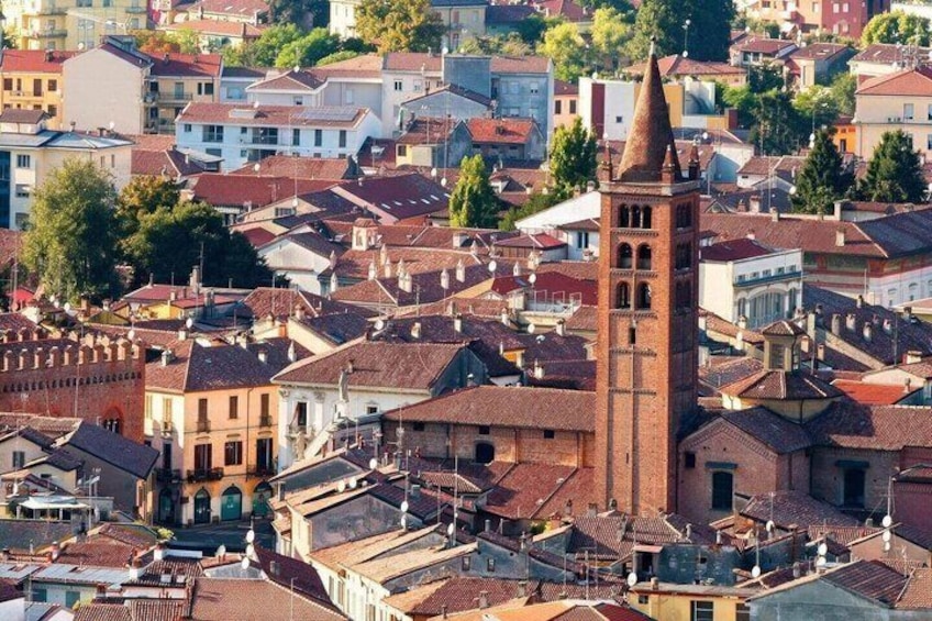 A densely packed urban area with a prominent church tower and surrounding residential buildings. 1
