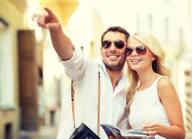 A couple taking a selfie with a city street in the background. 1