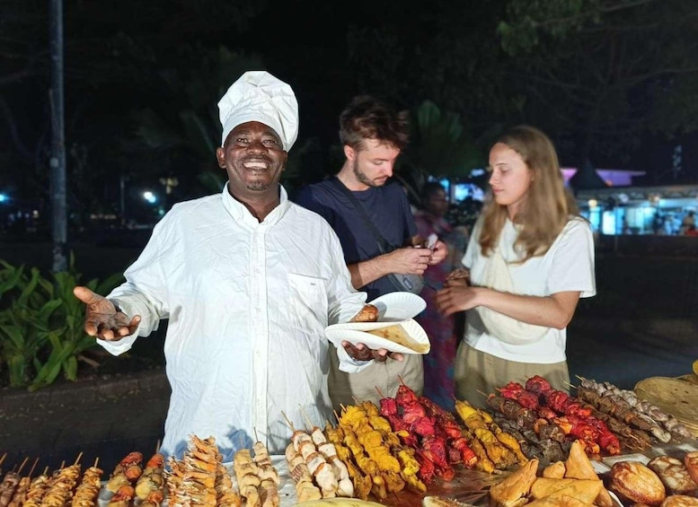 A street food vendor with a variety of grilled meats and skewers. 3