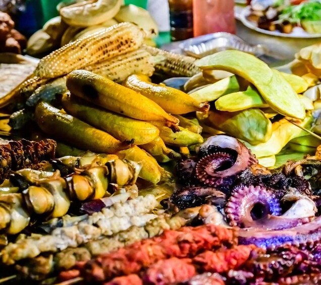A variety of seafood including octopus, squid, and possibly clams, displayed on a table. 5