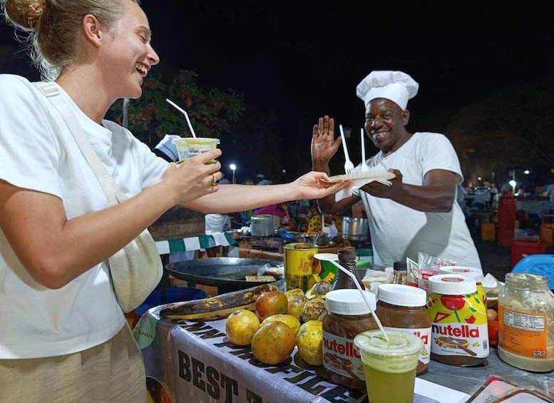 A street food vendor preparing food at night. 1