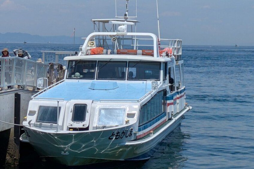 A boat docked at a pier with a clear view of the water and distant mountains. 4