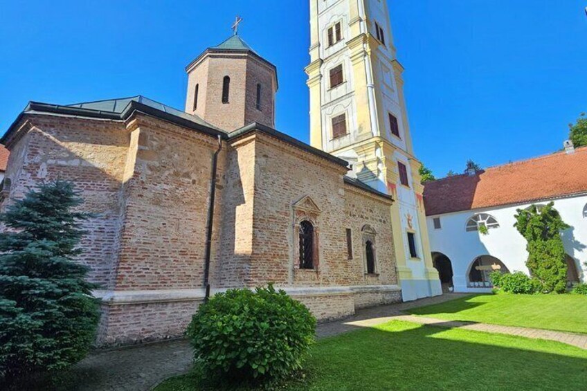 A church with a bell tower and a well-maintained lawn. 5