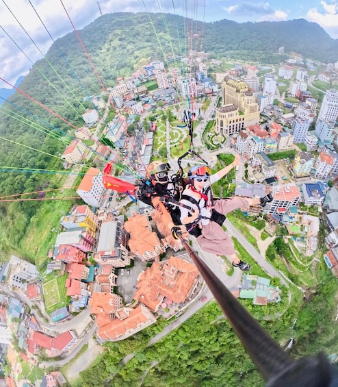 A person bungee jumping with a cityscape in the background. 2