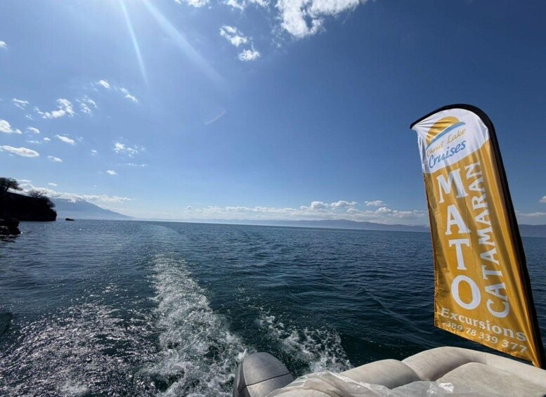 A boat on the ocean with a banner for Ocean Cruises. 2