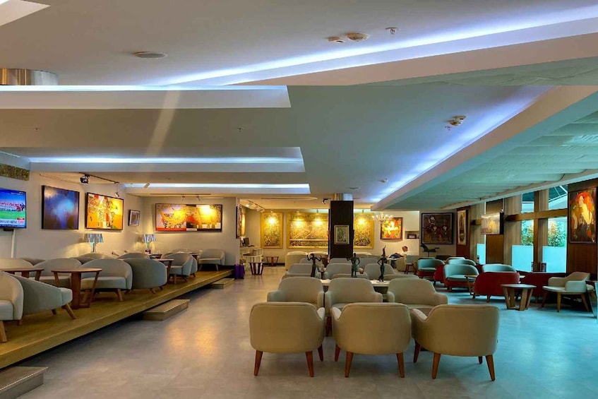 A modern interior with seating, artwork, and recessed lighting. 1