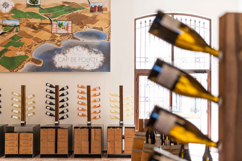 A wine cellar with bottles and boxes labeled 'CAP DE FOUSTE'. 4