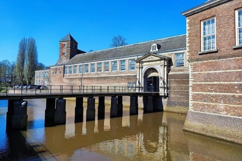 A historic building with a bridge over a canal. 2