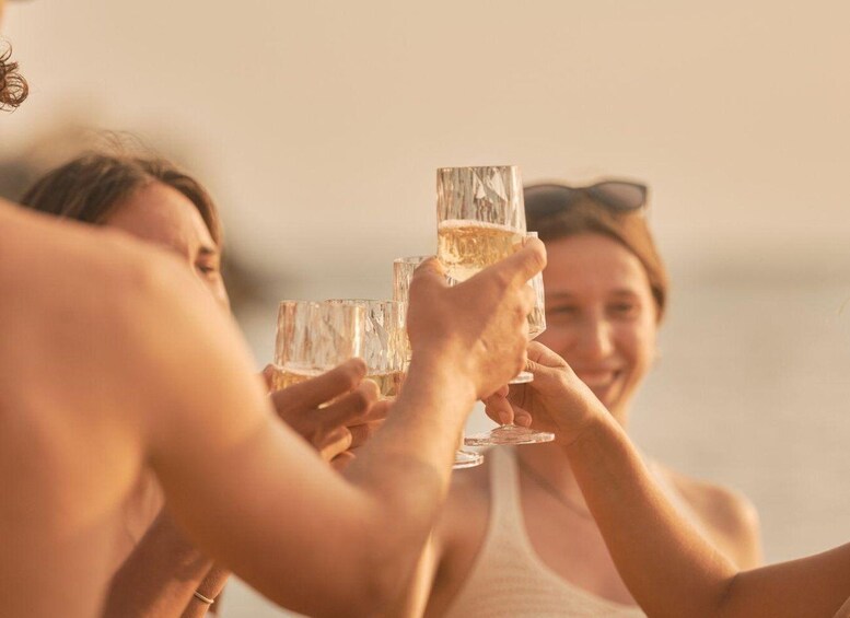 A group of people toasting with champagne glasses. 3