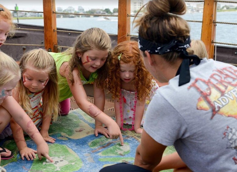 Children playing with a map on a boat. 2