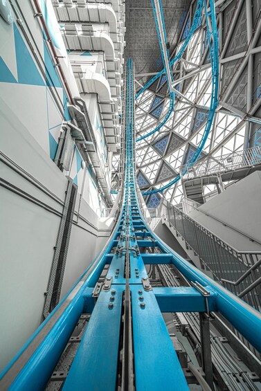 A complex industrial structure with blue and white elements, featuring a central blue beam and various metal frameworks. 2