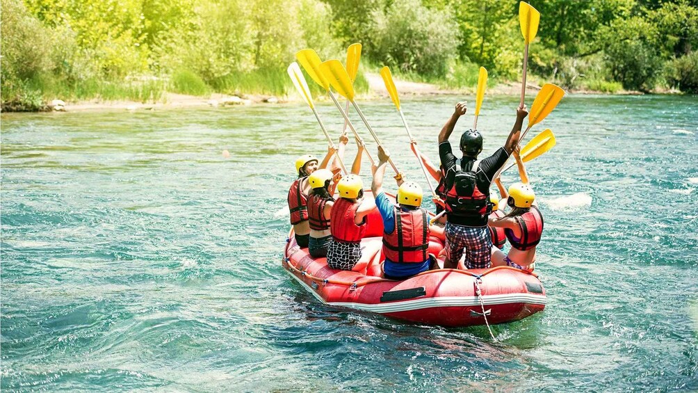 A group of people kayaking on a river. 1