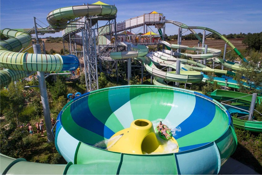 A water park with multiple water slides and a large wave pool. 5