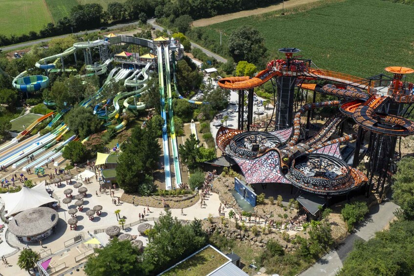 A water park with multiple slides and a large, colorful spiral ride. 2