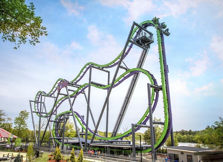 A roller coaster with multiple tracks and a green and purple color scheme. 5