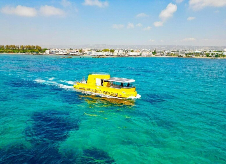 A yellow boat with 'WWW.PAPHOSSEALINES.COM' on its side, sailing on clear blue waters. 5