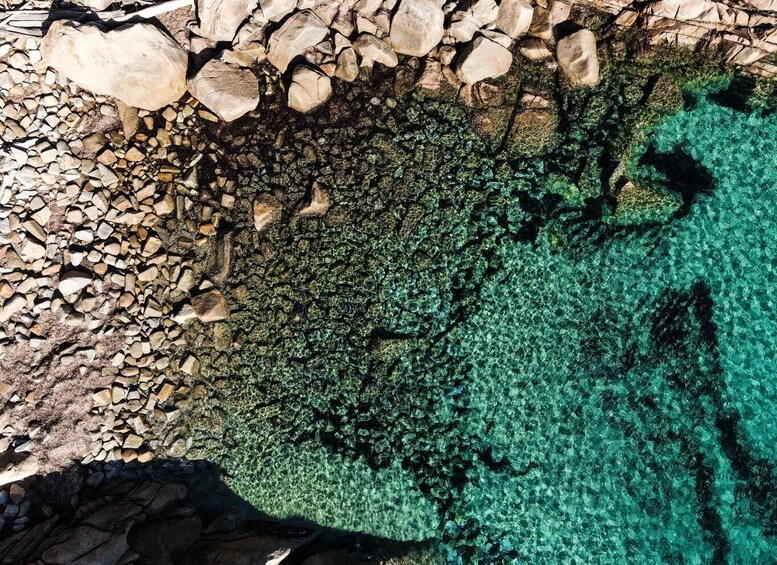 A rocky shoreline with clear turquoise water. 4