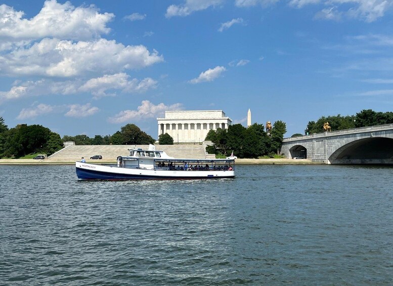 A river with a boat named 'Nightingale II' and the Lincoln Memorial in the background. 5
