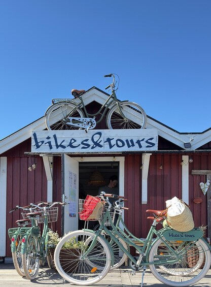 A building with a sign reading 'bikes & tours' and several bicycles parked in front. 2