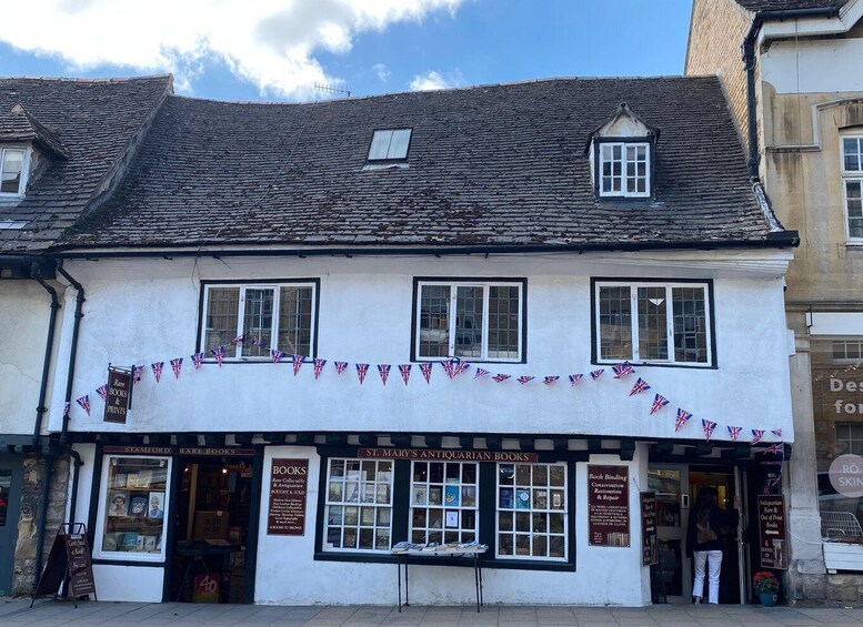 A white building with multiple windows and a sign for St. Mary's Antiquarian Books. 2